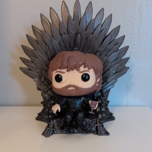 Funko Pop Figure with Brown Hair on Silver Throne